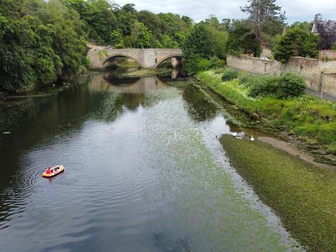 River running under an old stone bridge